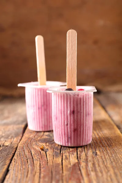 pink frozen yogurt with berries in cups