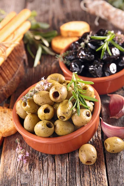black and green olives in bowls