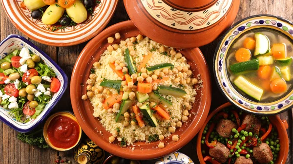 Arabic food assortment served on plates and bowls on table