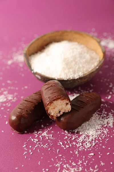 chocolate coconut candies served on table with bowl of shredded coconut