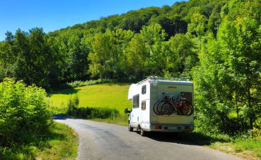 motor home in landscape of french countryside- Aveyron clipart