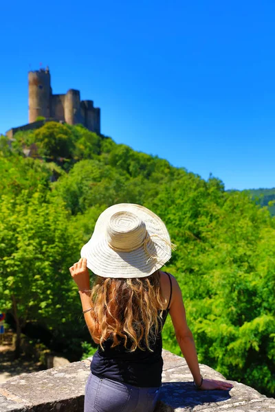 woman tourist in France- famous village Najac, old castle and forest