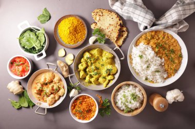 assortment of indian dish- naan, curry chicken, rice, tikka masala clipart