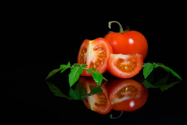 Fresh tomato on black background — Stock Photo, Image