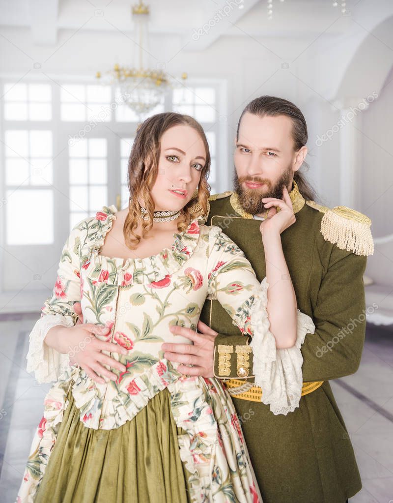 Beautiful couple man and woman in historical medieval costumes 