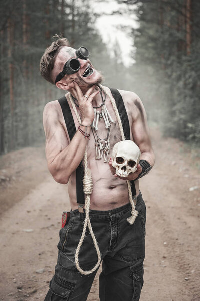 Cannibal Man in glasses with skull and rope outdoor