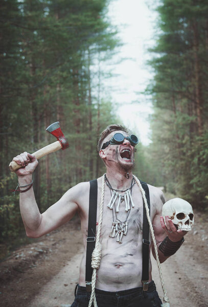 Cannibal Man in glasses with skull and rope outdoor