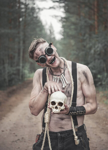 Cannibal Man in glasses with skull and rope outdoor