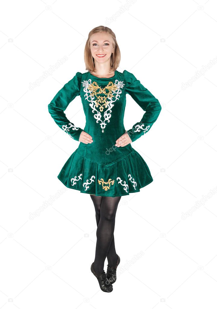 Beautiful young woman in Irish dance green dress isolated on white