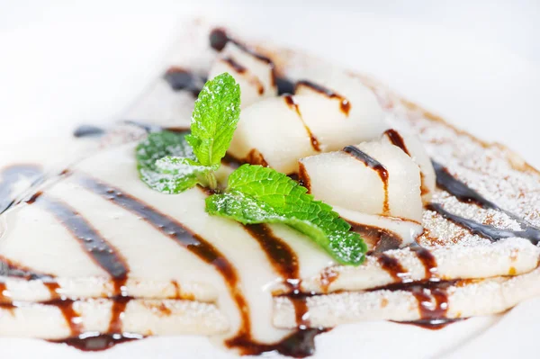 Thin delicious pancake with condensed milk on white — Stock Photo, Image