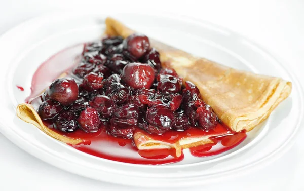Thin delicious pancake with berry jam on white — Stock Photo, Image