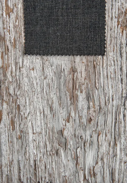 Fabric on old weathered wood background — Stock Photo, Image