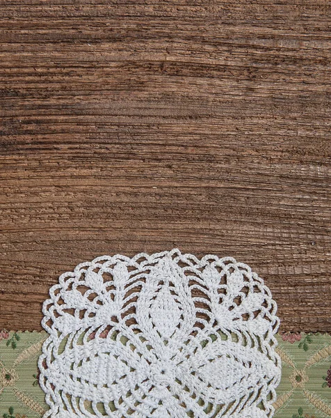 Floral fabric and lace on old wood background — Stock Photo, Image