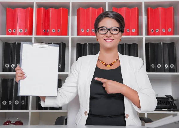 Modern happy beautiful business woman showing on blank paper — Stock Photo, Image