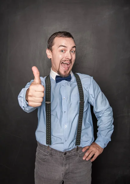 Happy business man or teacher showing thumbs up — Stock Photo, Image