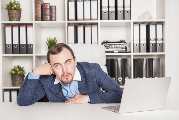 Bored young business man in office — Stock Photo, Image