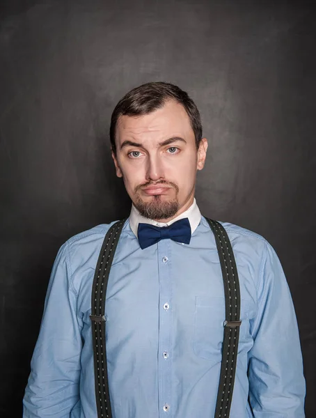Funny business man with sad expression on blackboard — Stock Photo, Image