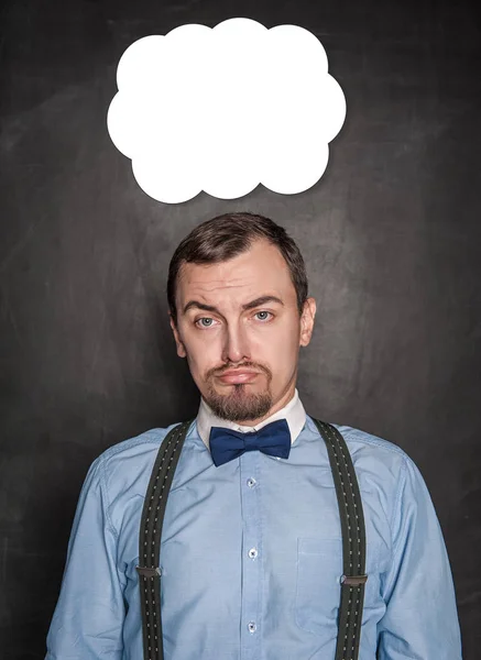 Funny business man with sad expression on blackboard