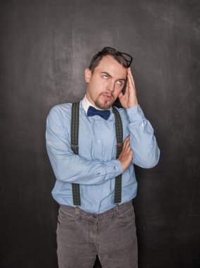 Tahta tebeşir tahtası üzerinde Düşünceli yakışıklı öğretmen 