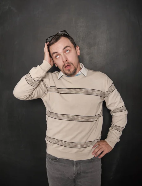 Tired funny teacher in eyeglasses on blackboard — Stock Photo, Image