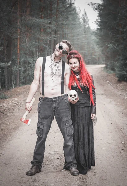 Terrible steampunk man and beautiful witch with skull — Stock Photo, Image