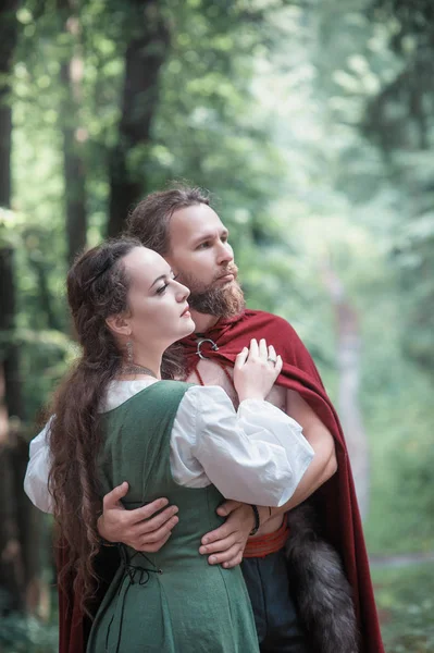 Brave Warrior Viking man with beautiful medieval woman standing