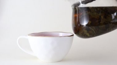 Bardağa çay dolduruyorum. Çaydanlıkta demlenmiş yeşil çay..