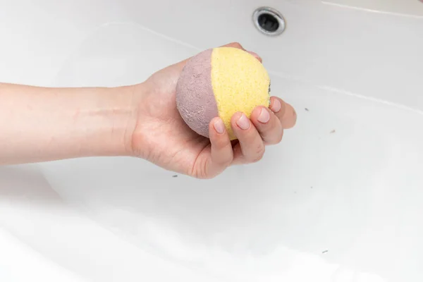 Hand made aromatic bath bombs on woman hand