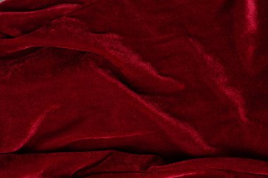 Red velvet fabric background with fold and waves. clipart