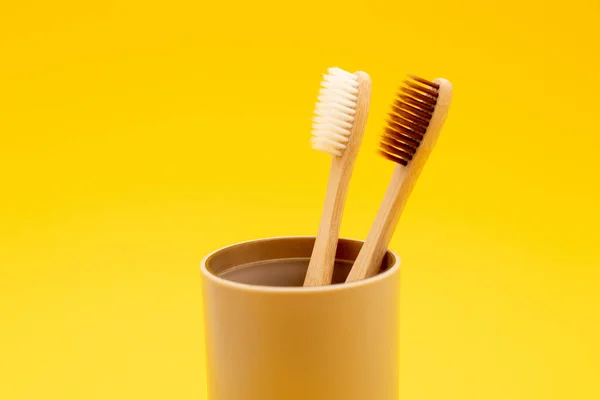 Two Bamboo Toothbrushes Glass Yellow Background — Stock Photo, Image