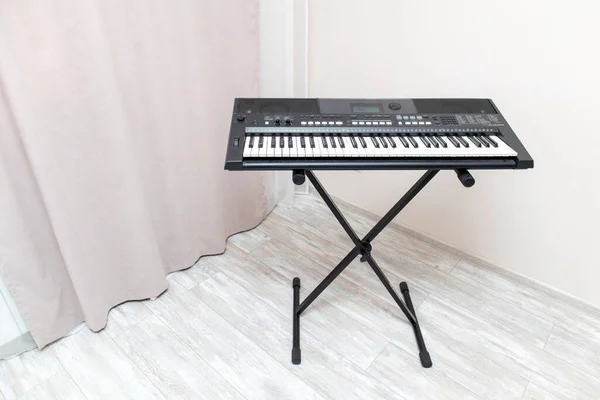 Electronic synthesizer piano keyboard in the apartment.