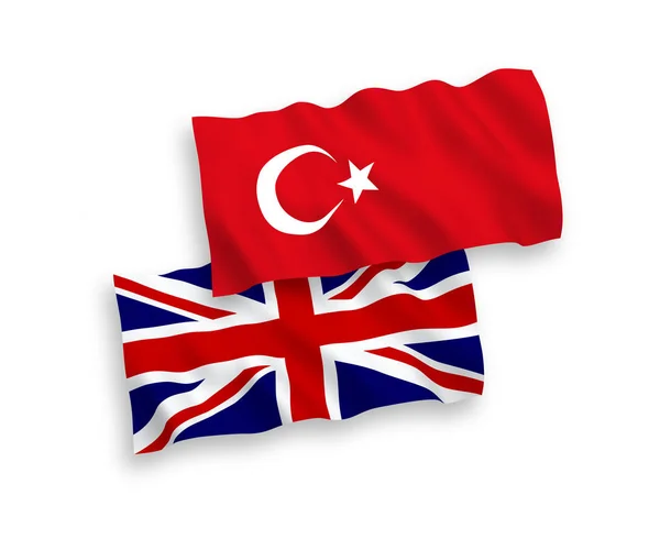 Bandeiras da Turquia e da Grã-Bretanha sobre um fundo branco —  Vetores de Stock