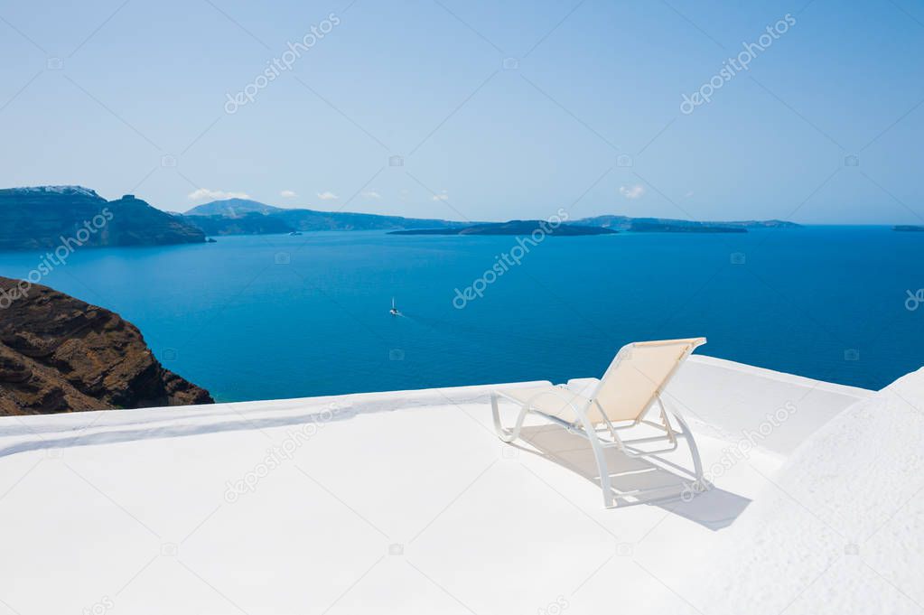Chaise lounge on the terrace with sea view. Santorini island, Greece