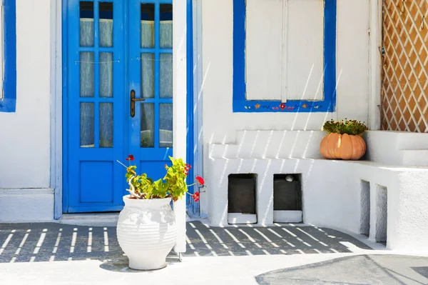 Traditional greek white architecture with blue doors and windows. Santorini island, Greece.