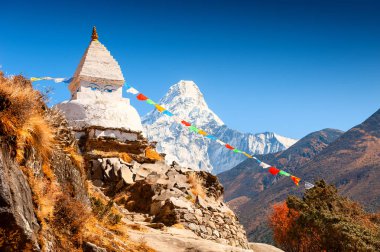 Buddhist stupa and view of Mount Ama Dablam in Himalayas, Nepal clipart