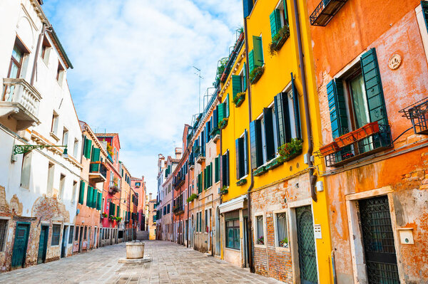 Beautiful street with old colorful architecture in Venice, Italy.