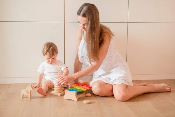 Cute Little Baby Boy Playing His Mother Wooden Stacking Rings — Stock Photo, Image