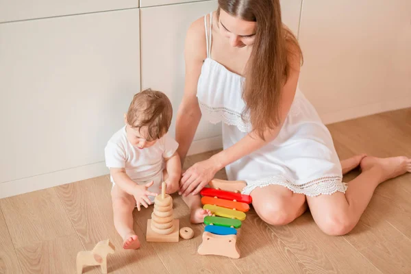 Cute Little Baby Boy Playing His Mother Wooden Stacking Rings — Stock Photo, Image