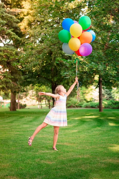 Szczęśliwa Dziewczynka Bawi Się Duży Pęczek Helu Wypełnione Kolorowe Balony — Zdjęcie stockowe