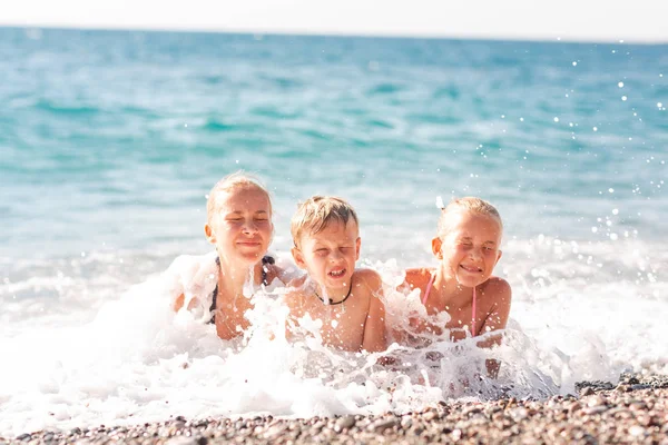 Niños felices en la playa divirtiéndose — Foto de Stock