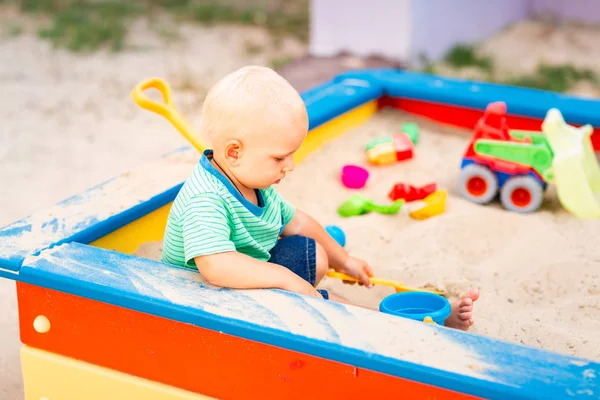 Cute baby boy playing in the sandbox — Stock Photo, Image