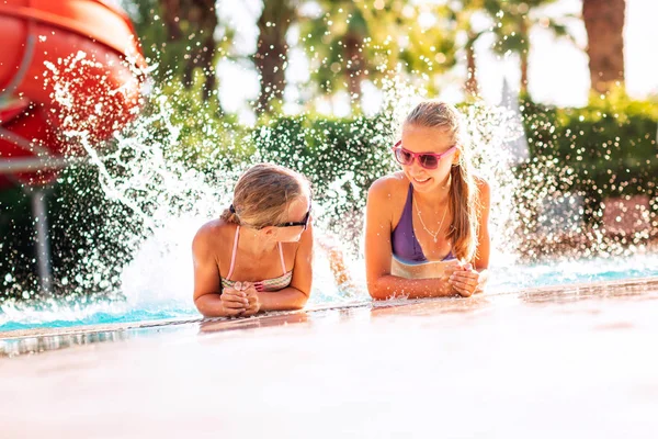 Feliz hermosas chicas divirtiéndose en la piscina — Foto de Stock