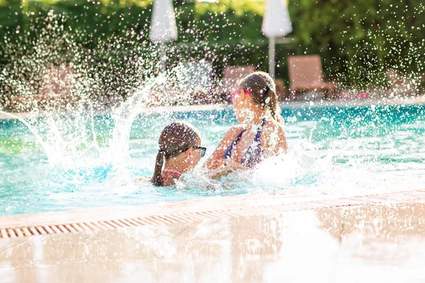 Happy beautiful girls having fun at the pool — Stock Photo, Image