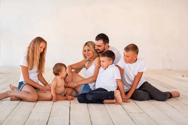 Big happy family with four kids indoors