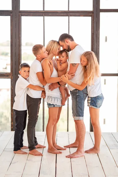 Big happy family with four kids indoors