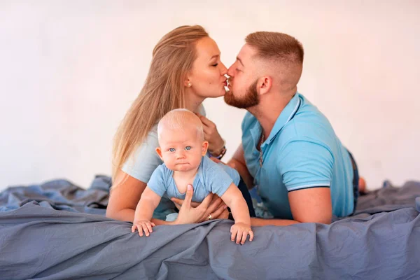 Young happy family with the baby indoors — Stock Photo, Image