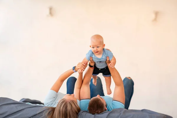 Young happy family with the baby indoors — Stock Photo, Image