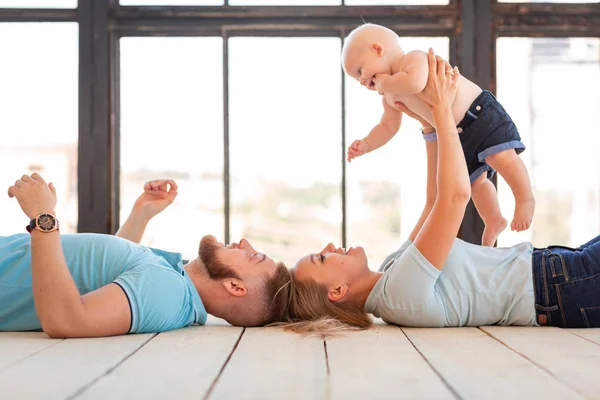 Young happy family with the baby indoors — Stock Photo, Image