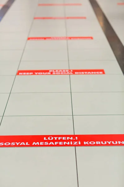 Keep Your Distance Social Distancing signs in different languages at the Antalya airport Turkey
