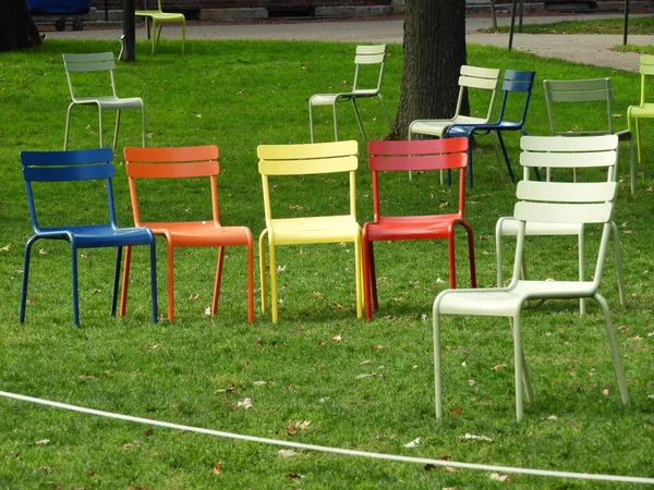 Colorfull chairs in park empty as people is in lockdown
